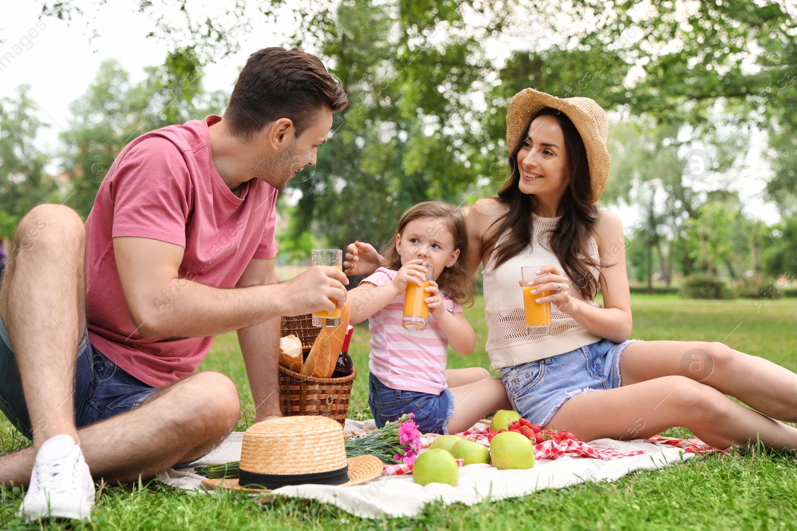 Photo of Happy family having picnic in park on summer day