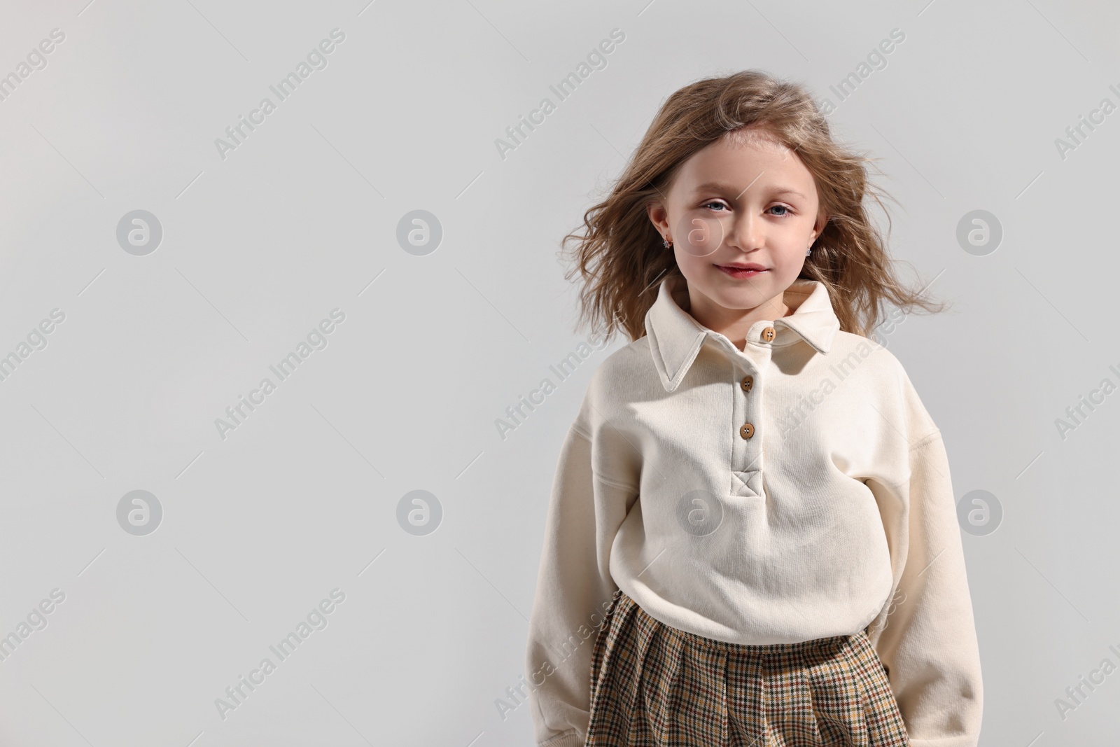 Photo of Fashion concept. Stylish girl posing on light grey background. Space for text