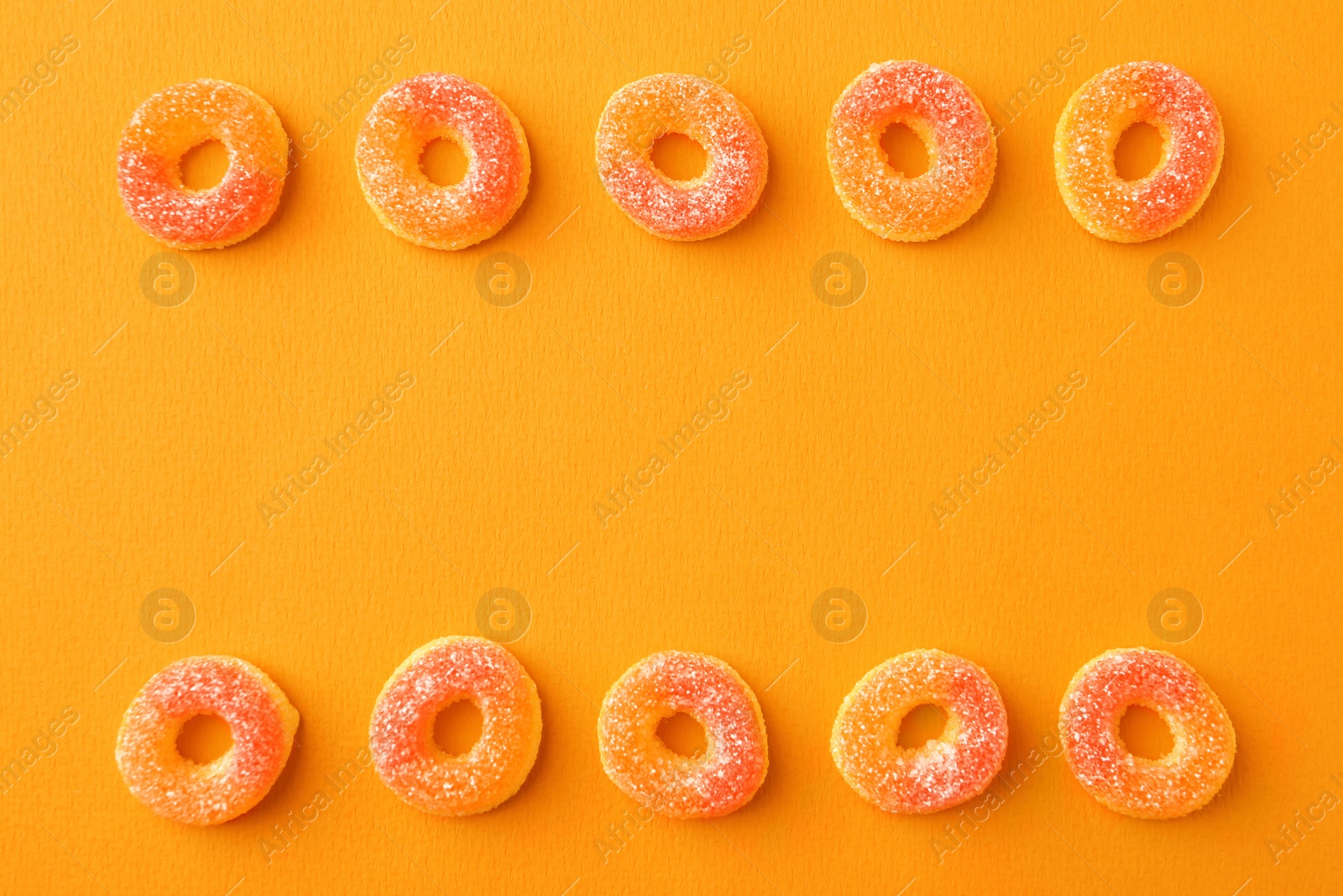 Photo of Flat lay composition with delicious jelly candies on color background. Space for text