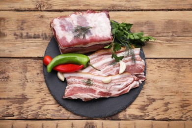 Pork fatback and ingredients on wooden table, top view