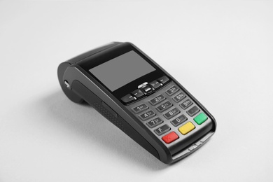 Photo of New modern payment terminal on grey background