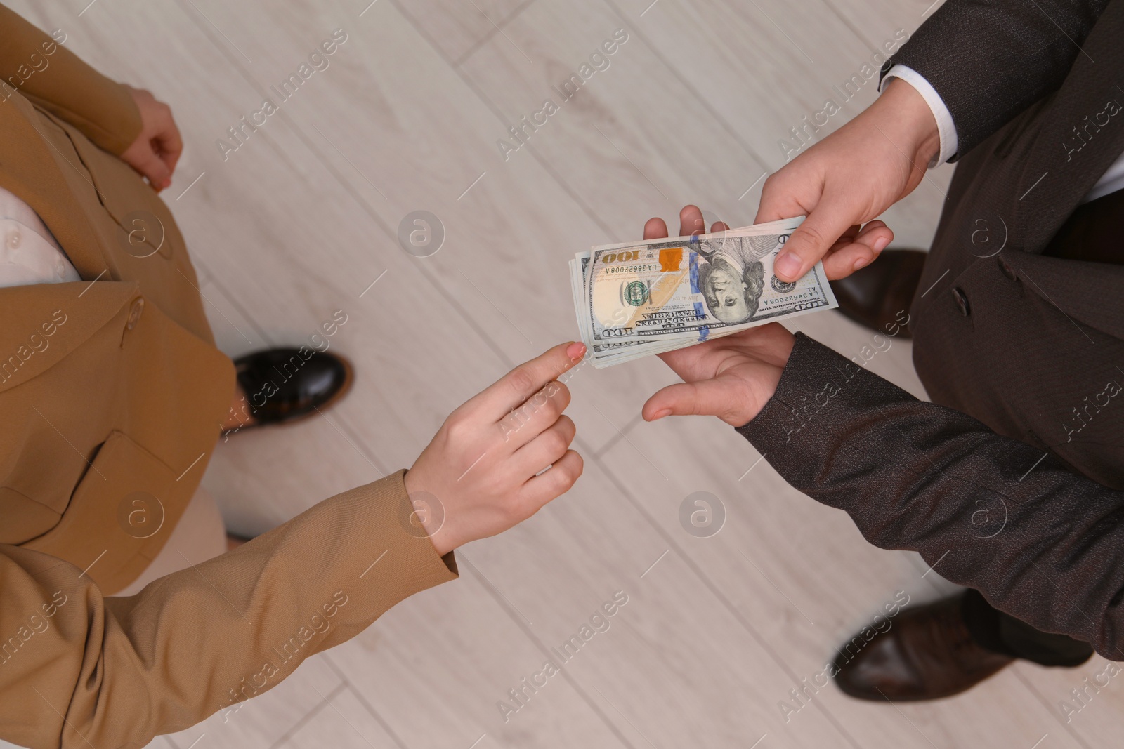 Photo of Man giving money to woman indoors, above view. Currency exchange