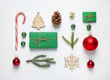 Photo of Christmas tree branches and festive decoration on white background, top view