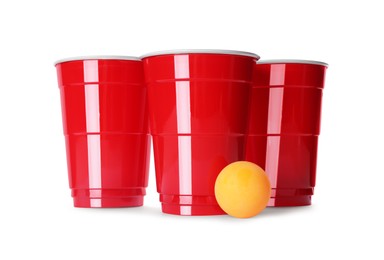 Photo of Red plastic cups and ball for beer pong on white background