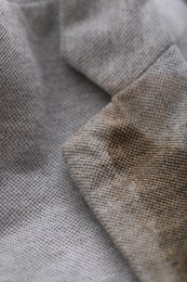 Photo of Grey jacket with stain of coffee, closeup