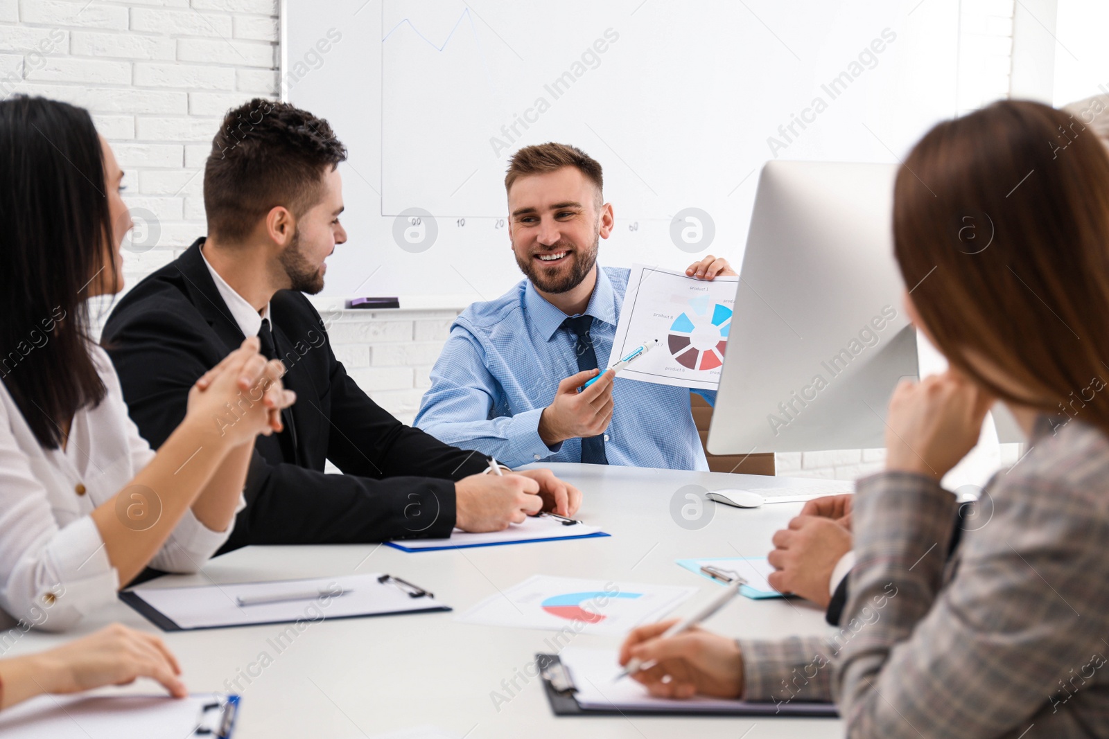 Photo of Professional business trainer working with people in office