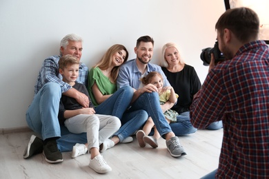 Photo of Professional photographer taking photo of family in studio