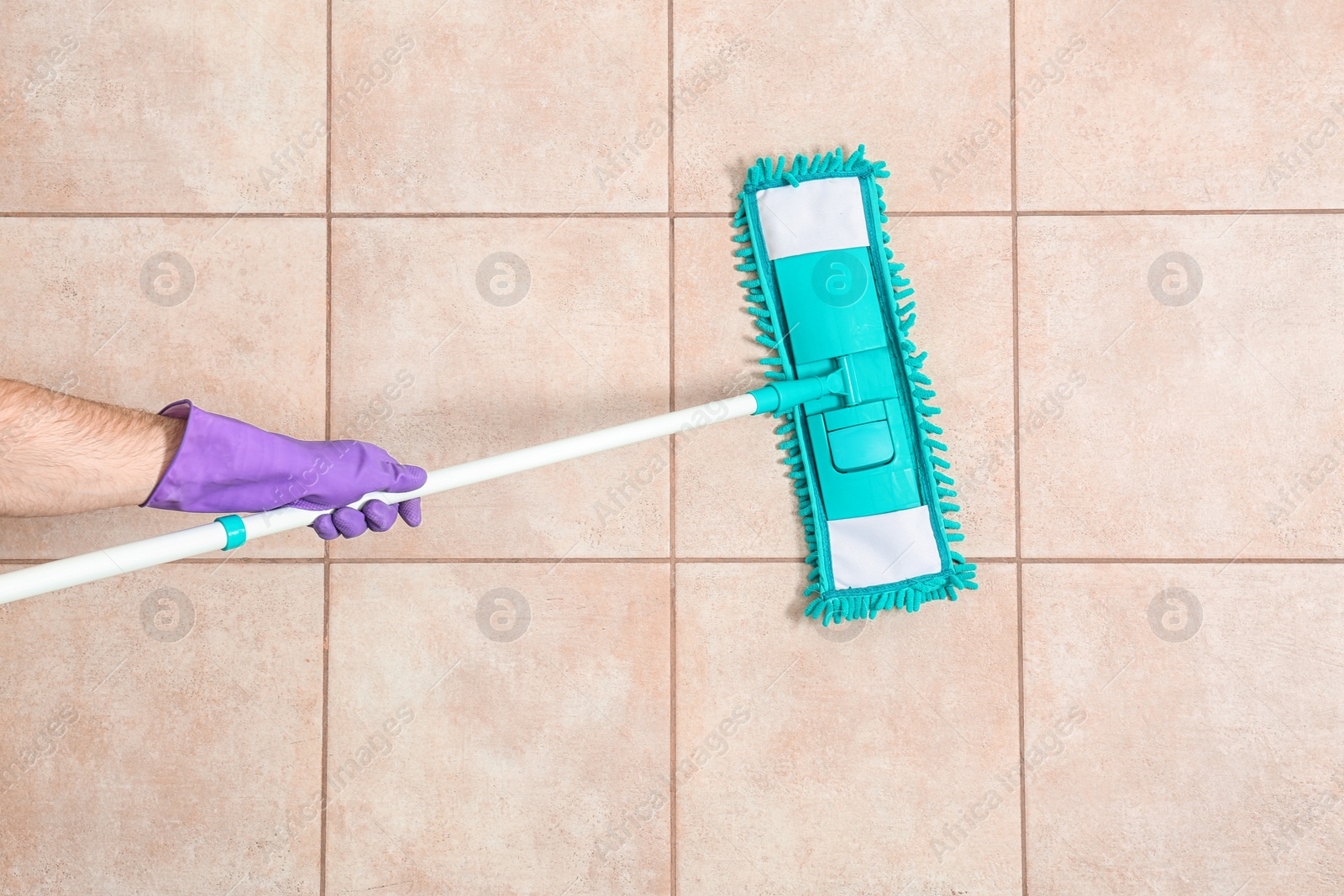 Photo of Man cleaning floor with mop, top view