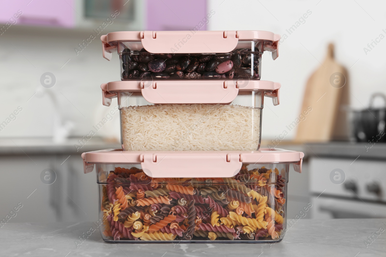 Photo of Stacked boxes with different food on table in kitchen