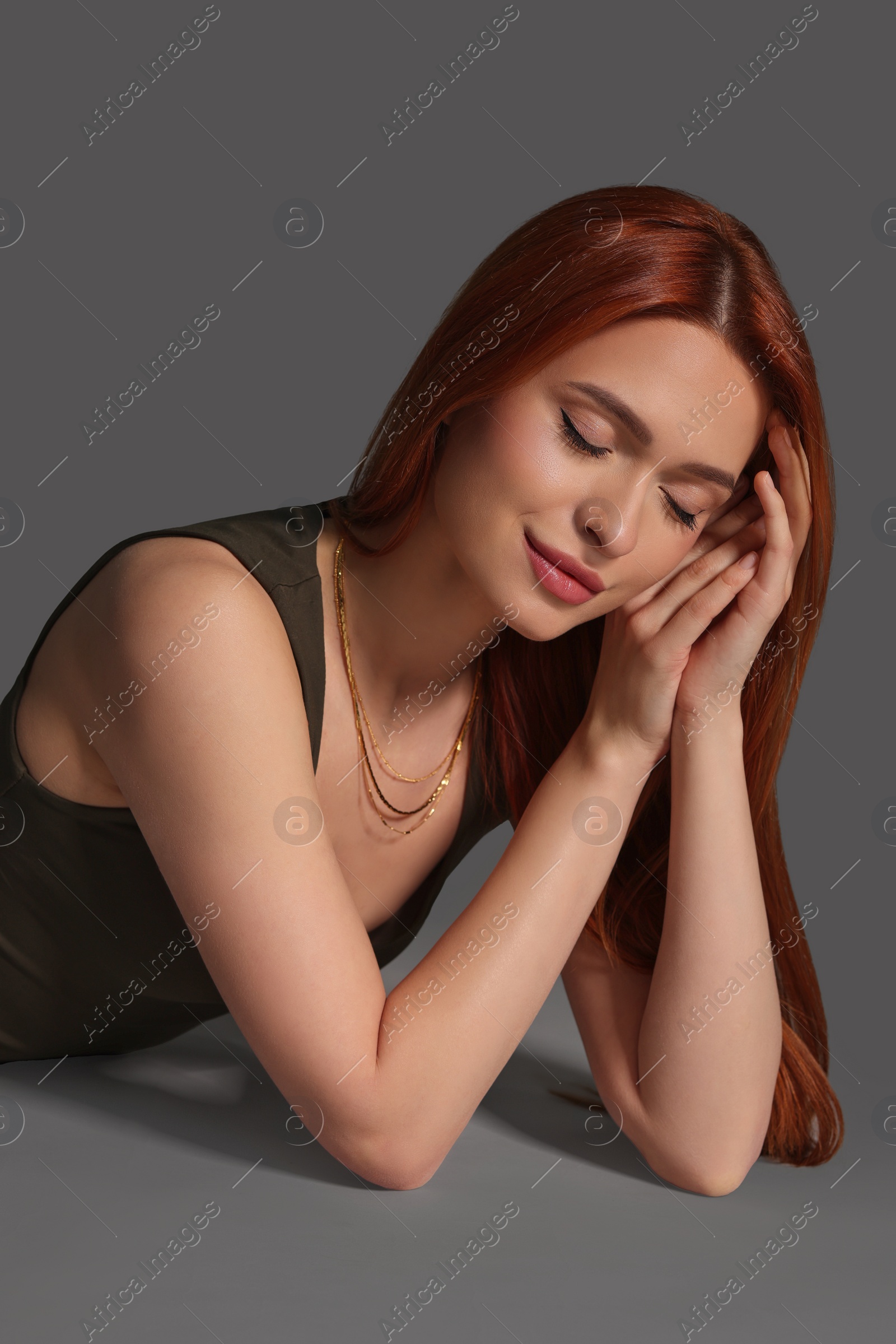 Photo of Portrait of beautiful young woman on gray background