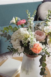 Photo of Bouquet of beautiful flowers on table indoors