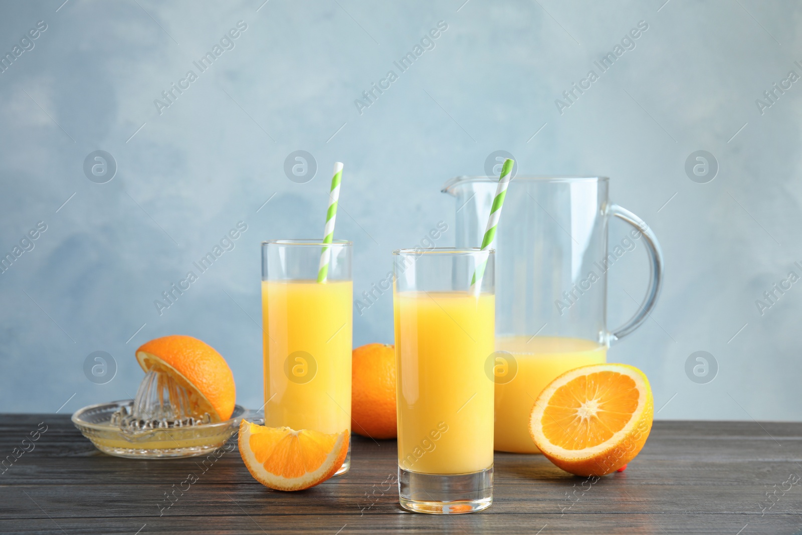 Photo of Composition with orange juice and fresh fruit on table