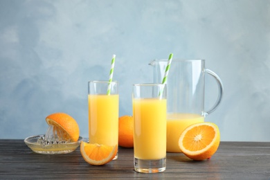 Composition with orange juice and fresh fruit on table