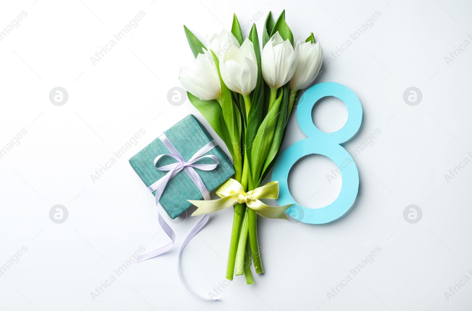 Photo of 8 March greeting card design with tulips and gift on white background, top view