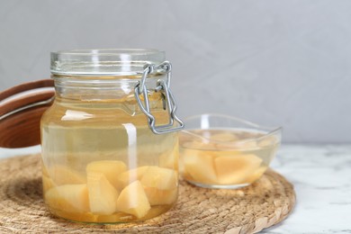 Photo of Delicious quince drink on white marble table. Space for text