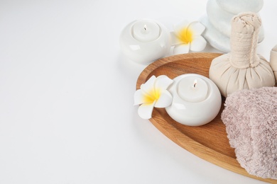 Photo of Beautiful spa composition with candles and flowers on white background