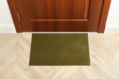 New clean green mat near entrance door