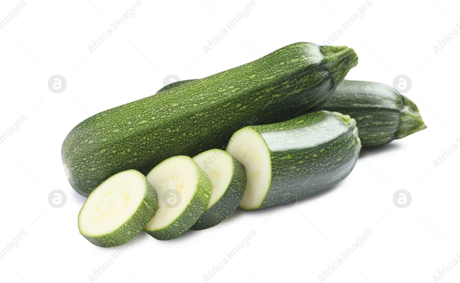 Photo of Whole and cut green ripe zucchinis isolated on white