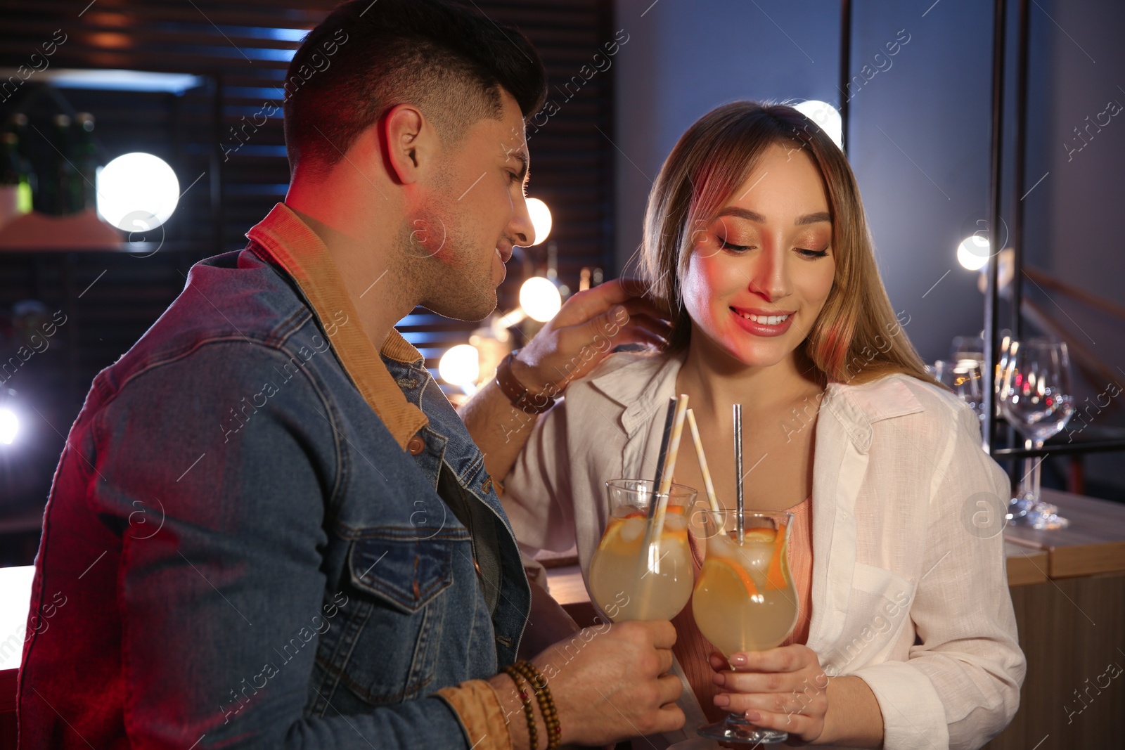 Photo of Man and woman flirting with each other in bar