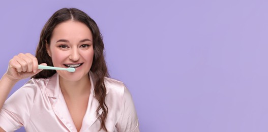 Woman with braces cleaning teeth on violet background. Banner design with space for text