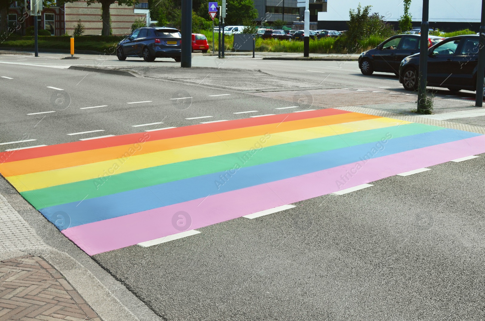Photo of Bright rainbow LGBT pride flag on city road