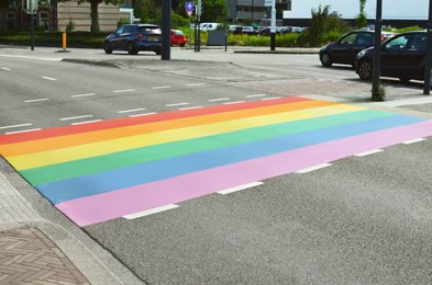 Bright rainbow LGBT pride flag on city road