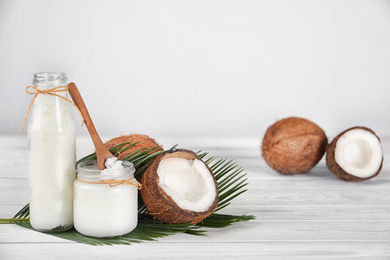 Photo of Composition with fresh coconut oil on white wooden table, space for text. Cooking ingredient