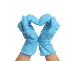 Doctor in medical gloves showing heart with hands on white background, closeup