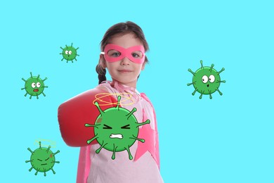 Image of Cute little girl wearing superhero costume and boxing gloves fighting against viruses on turquoise background