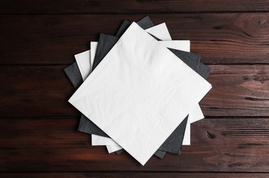 Photo of Clean napkins on wooden table, top view