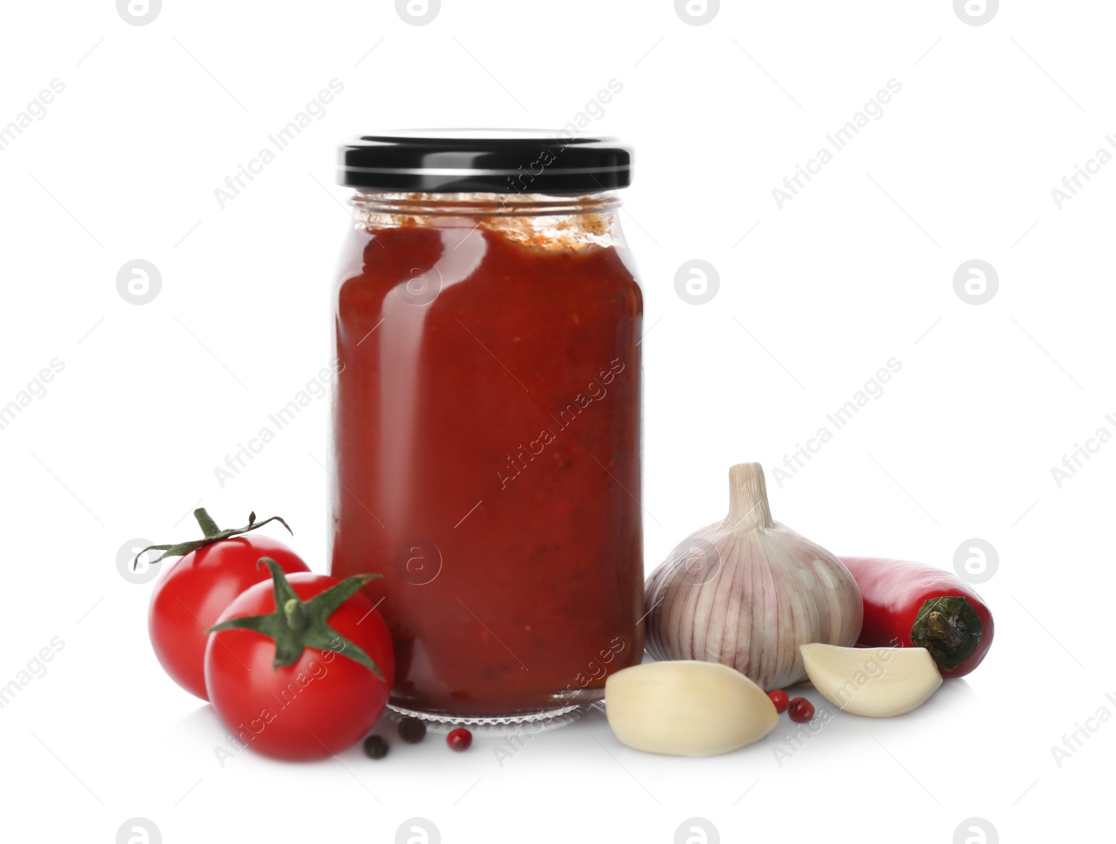 Photo of Jar of tomato paste and fresh ingredients on white background