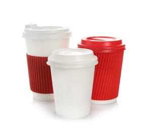 Photo of Takeaway paper coffee cups with lids on white background. Space for design