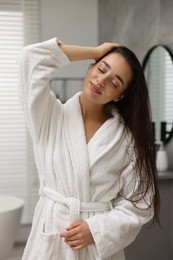 Photo of Beautiful young woman after shower in bathroom