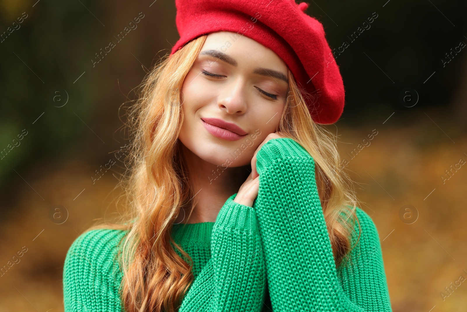 Photo of Portrait of beautiful woman wearing autumn sweater outdoors