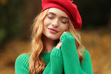 Portrait of beautiful woman wearing autumn sweater outdoors