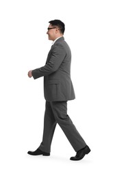 Businessman in suit walking on white background