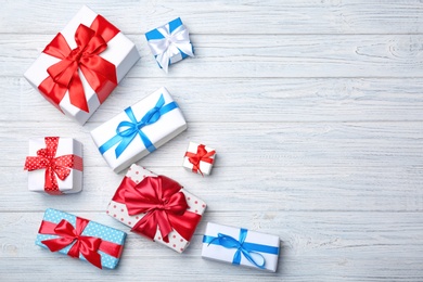 Photo of Flat lay composition with different gift boxes on wooden background