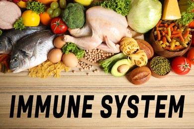 Immune system boosting with proper nutrition. Different foods on wooden table, flat lay