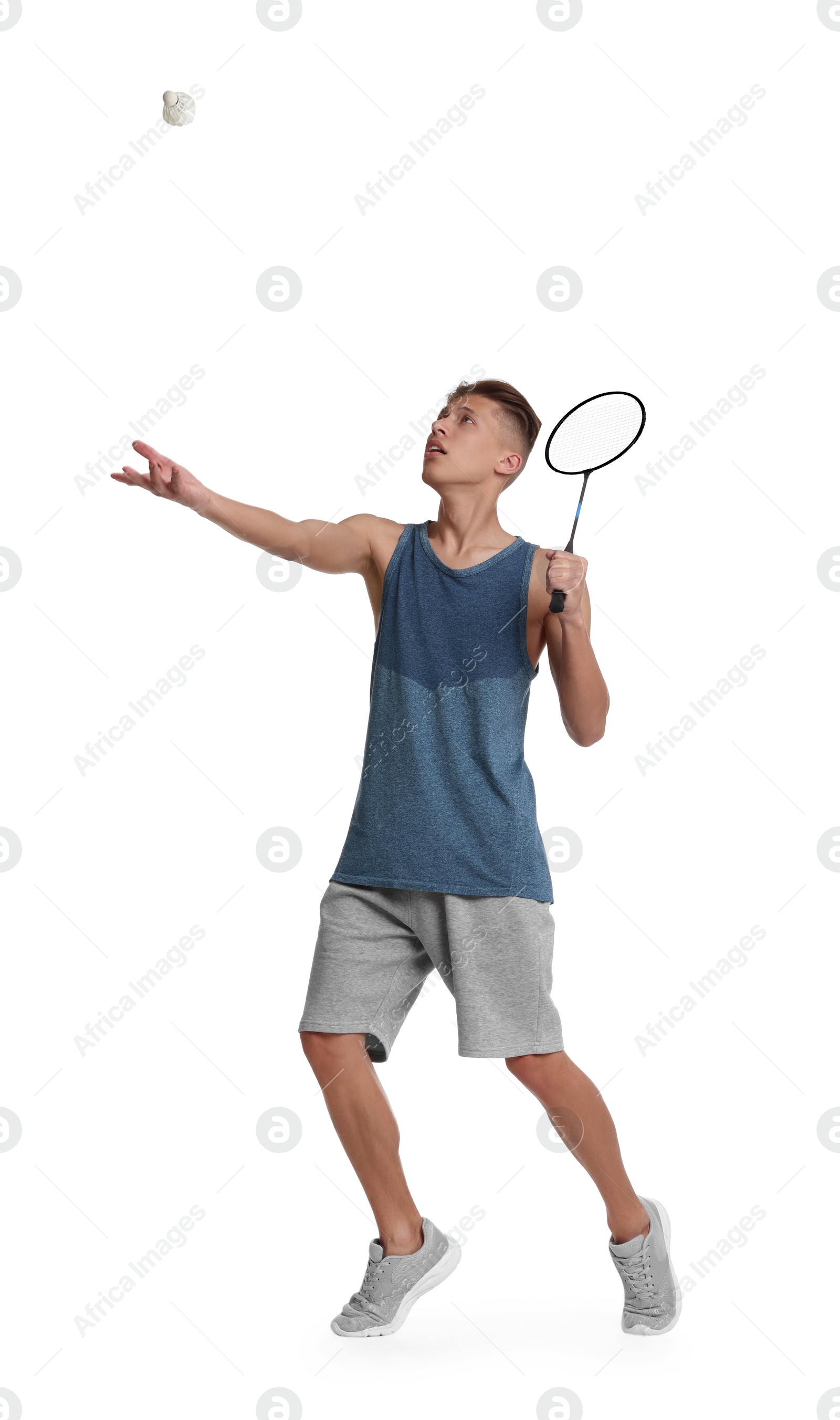 Photo of Young man playing badminton with racket and shuttlecock on white background