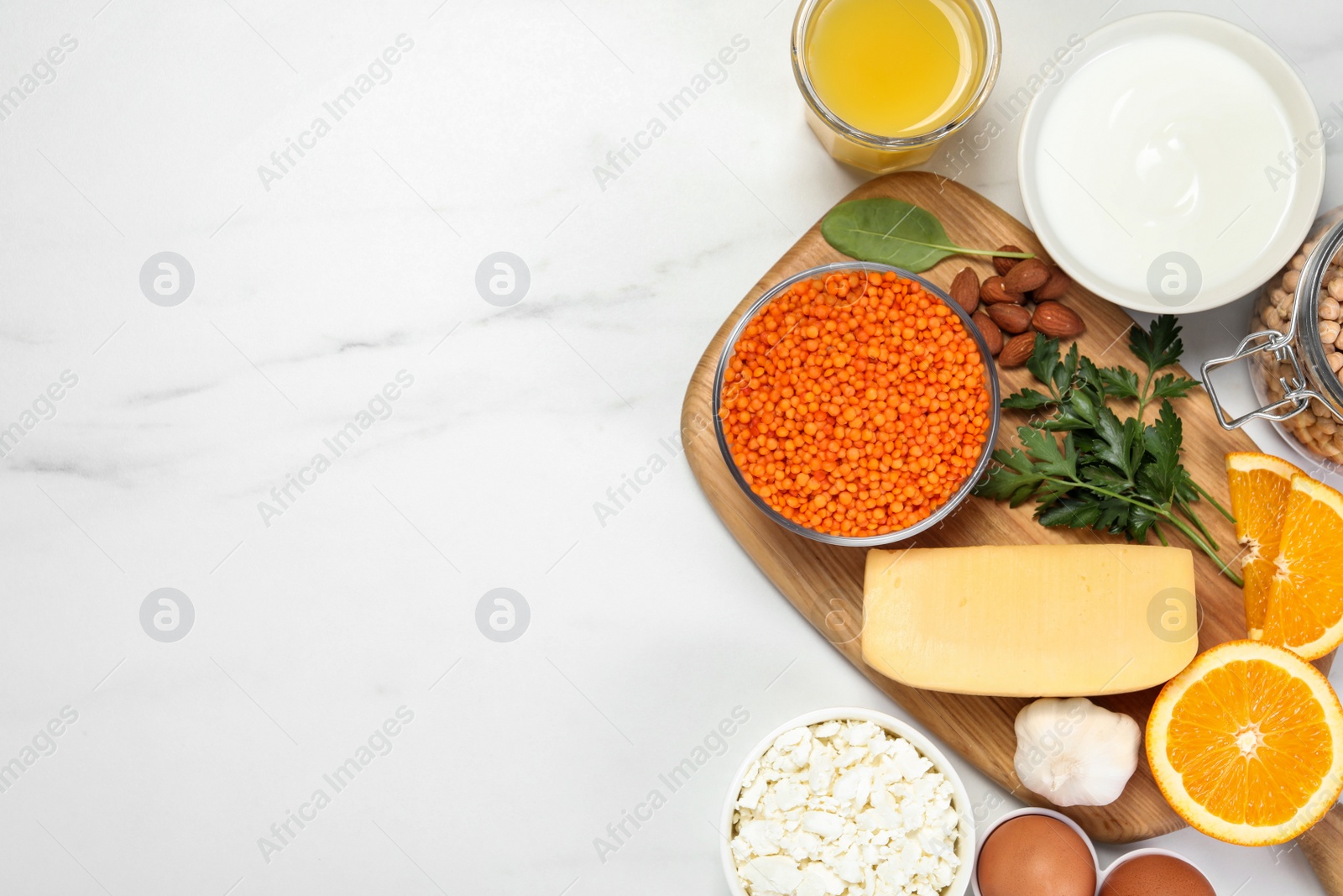 Photo of Set of natural food high in calcium on white marble table, flat lay. Space for text