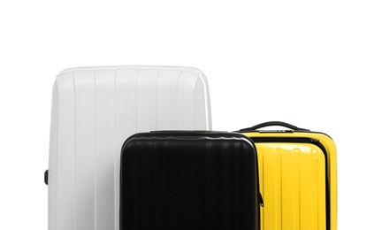 New suitcases packed for journey on white background