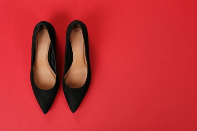 Photo of Pair of female shoes on color background, top view