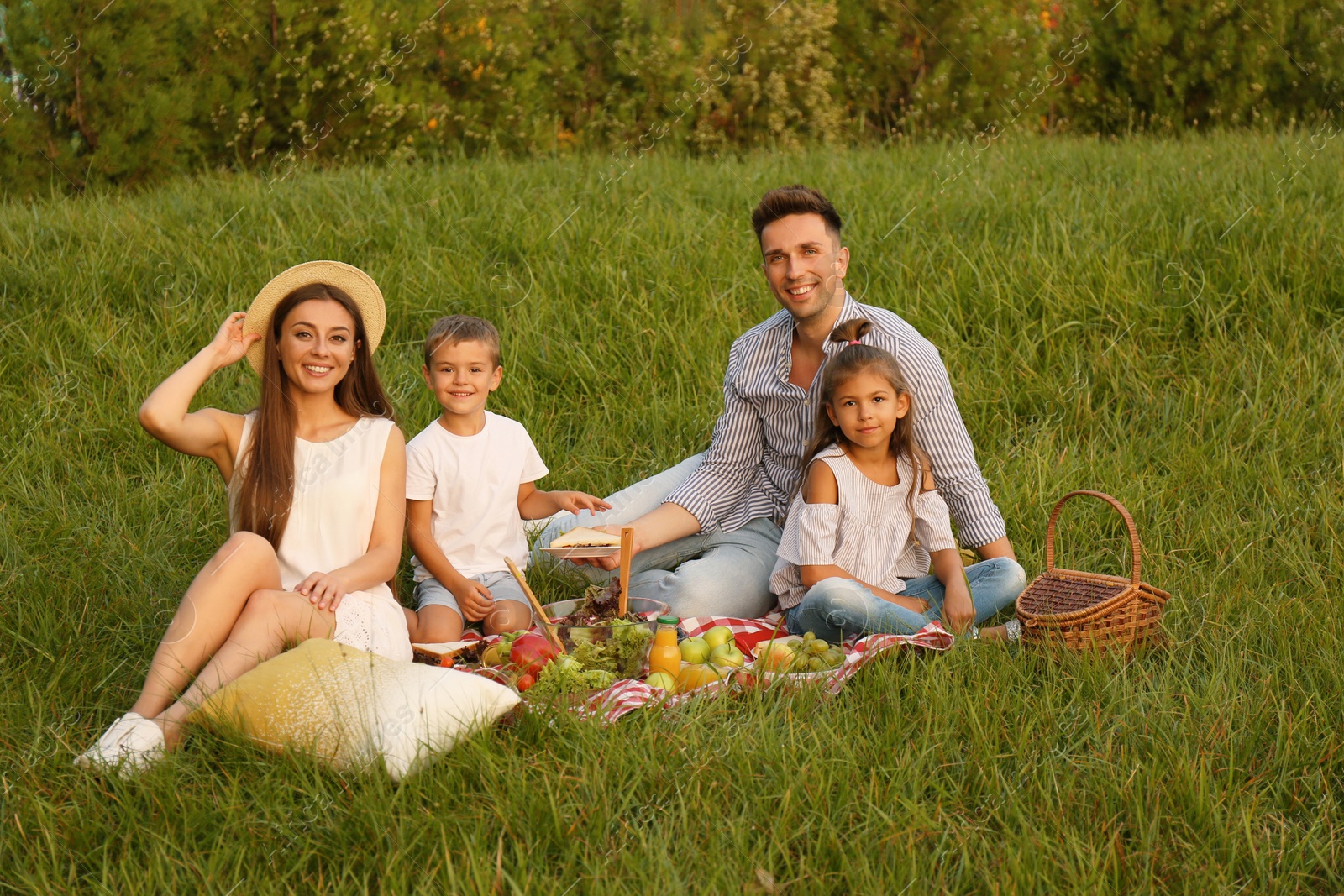 Photo of Happy family having picnic in park on summer day