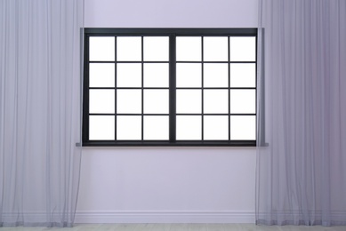 Photo of Empty room with window and open curtains. Home interior