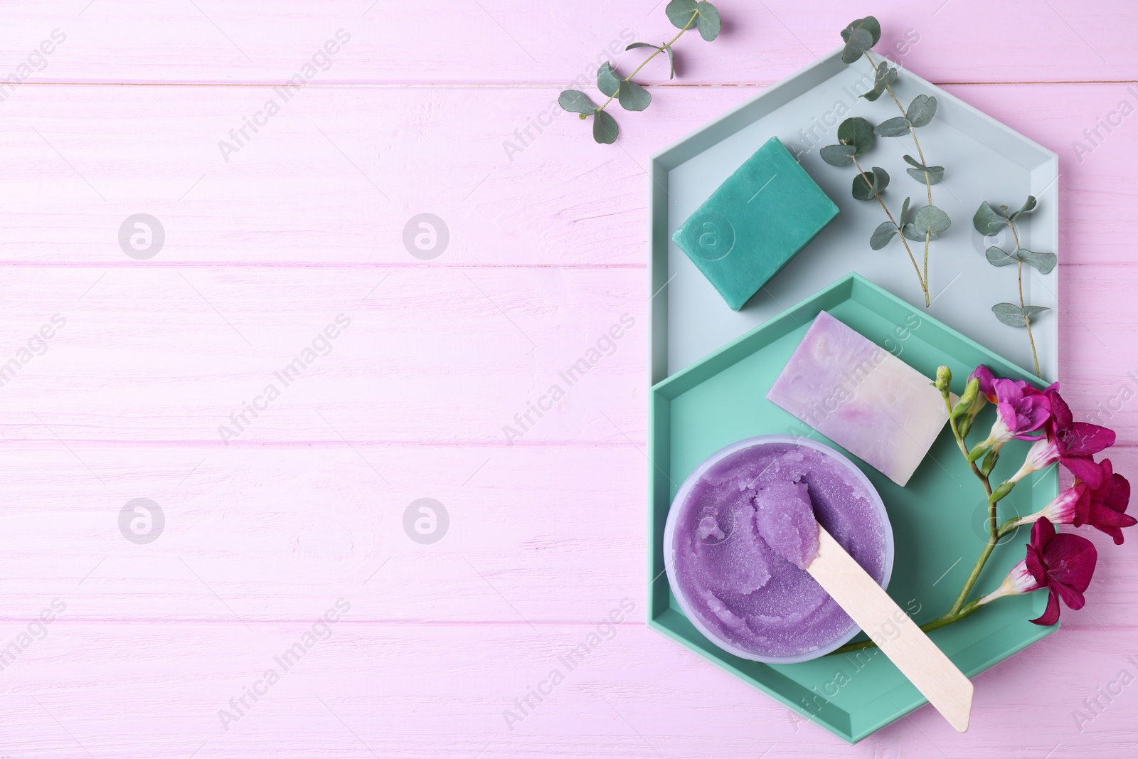 Photo of Flat lay composition with handmade soap and scrub on wooden table. Space for text