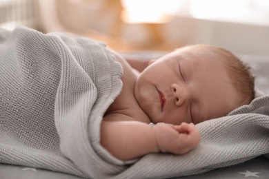 Photo of Cute little baby sleeping on bed, closeup
