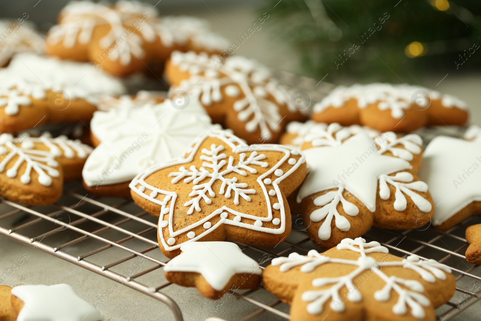 Photo of Tasty Christmas cookies with icing on light table, closeup