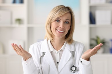 Photo of Portrait of smiling doctor on blurred background