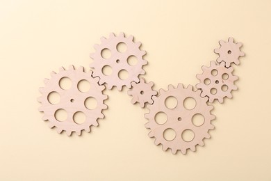 Photo of Business process organization and optimization. Scheme with wooden figures on beige background, top view