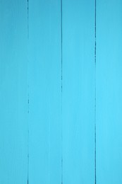 Texture of light blue wooden surface as background, closeup